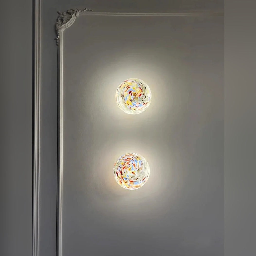 Orbinth swirl art glass wall sconce in an ornate hallway, warm ambient light