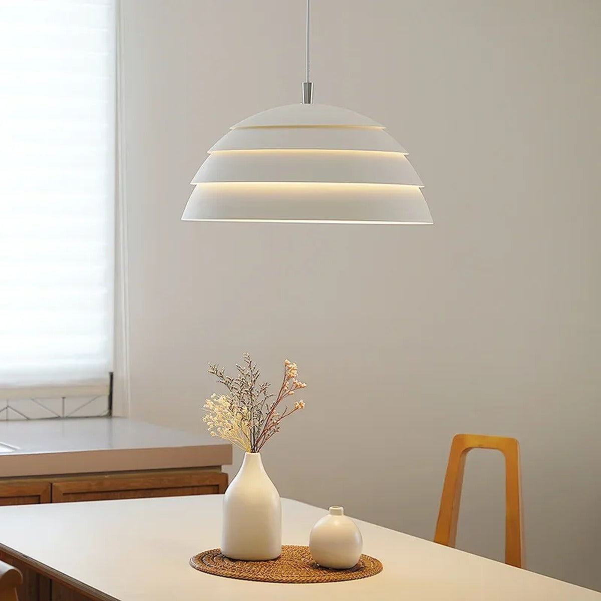 Tiered Dome LED Pendant Light Brevion — warm white tiers glowing, dining table