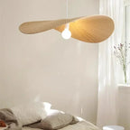 Galivora pleated wave pendant light in Ephedra tan finish above a bed