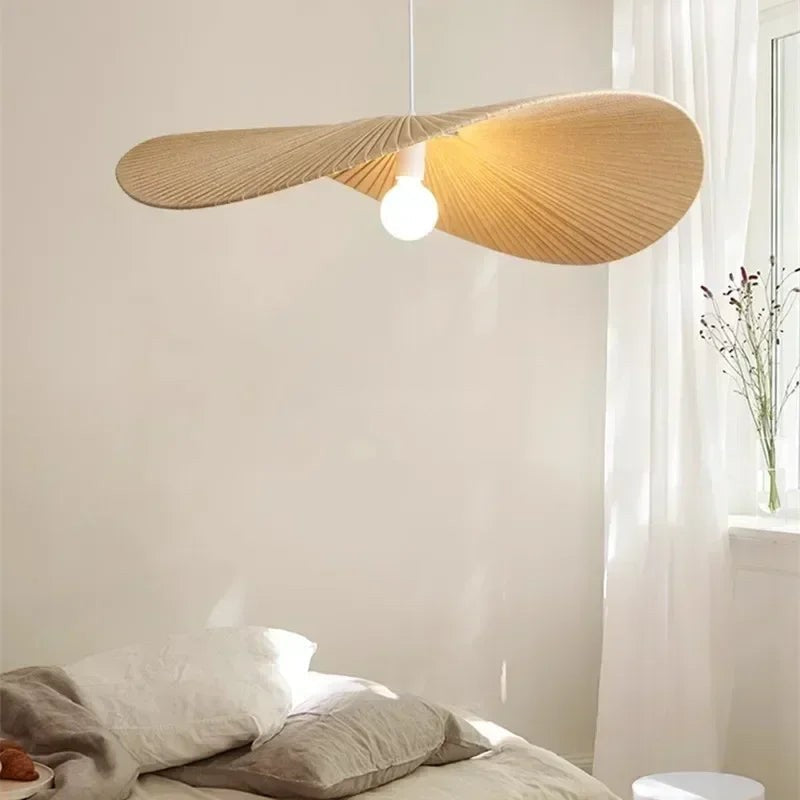 Galivora pleated wave pendant light in Ephedra tan finish above a bed