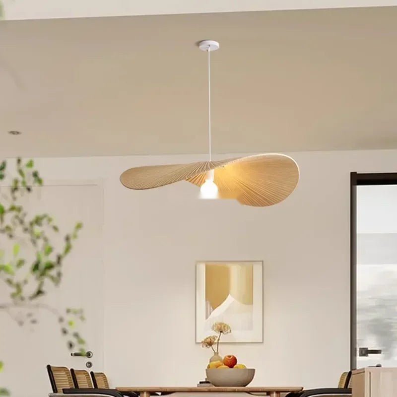 Galivora pleated wave pendant light in Ephedra tan finish above a dining table