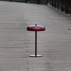 Cmoona minimalist disc metal table lamp – Crimson Red on wooden outdoor surface