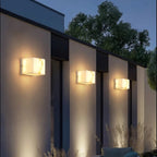 Avrexon alabaster cube outdoor wall sconce — three units on architectural facade at dusk