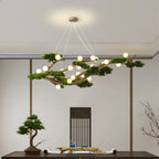 Veloris pine branch chandelier suspended above a dining table, warm ambient lighting