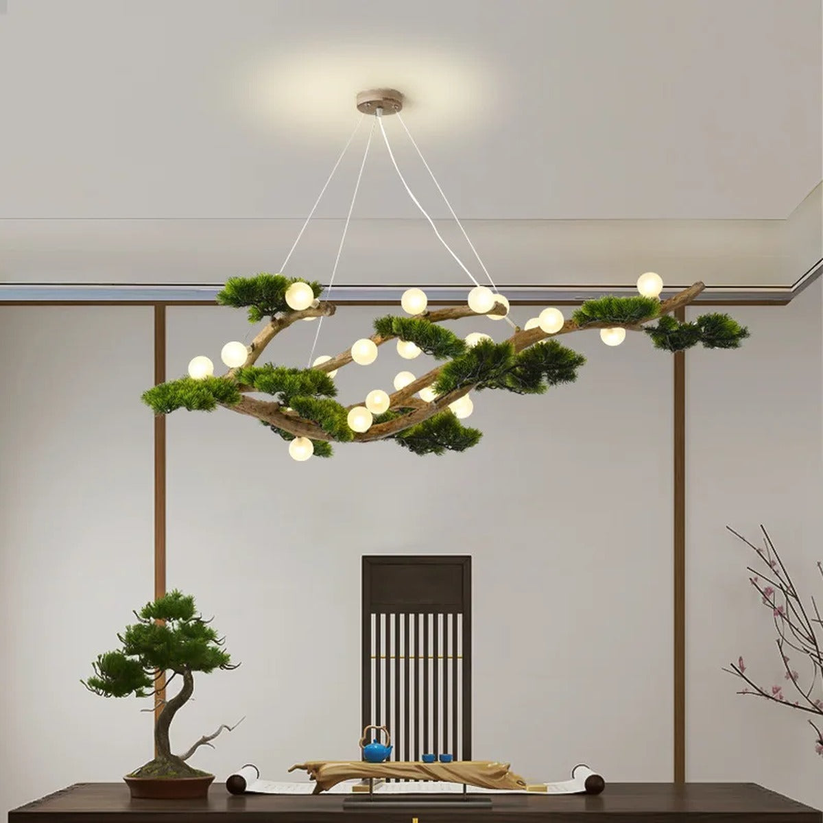 Veloris pine branch chandelier suspended above a dining table, warm ambient lighting