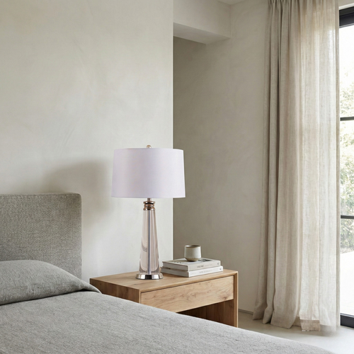 Orindel table lamp with white fabric shade on a wood nightstand in a modern bedroom