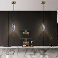 Ovaline pendant lights above a dark kitchen island