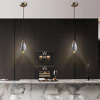 Ovaline pendant lights above a dark kitchen island