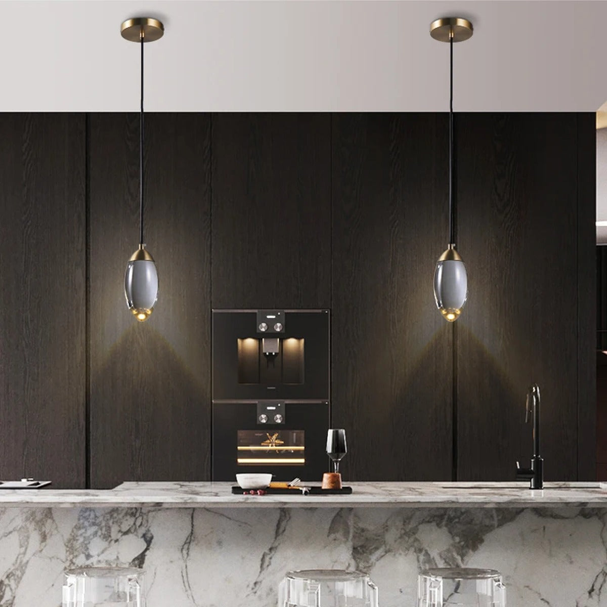 Ovaline pendant lights above a dark kitchen island