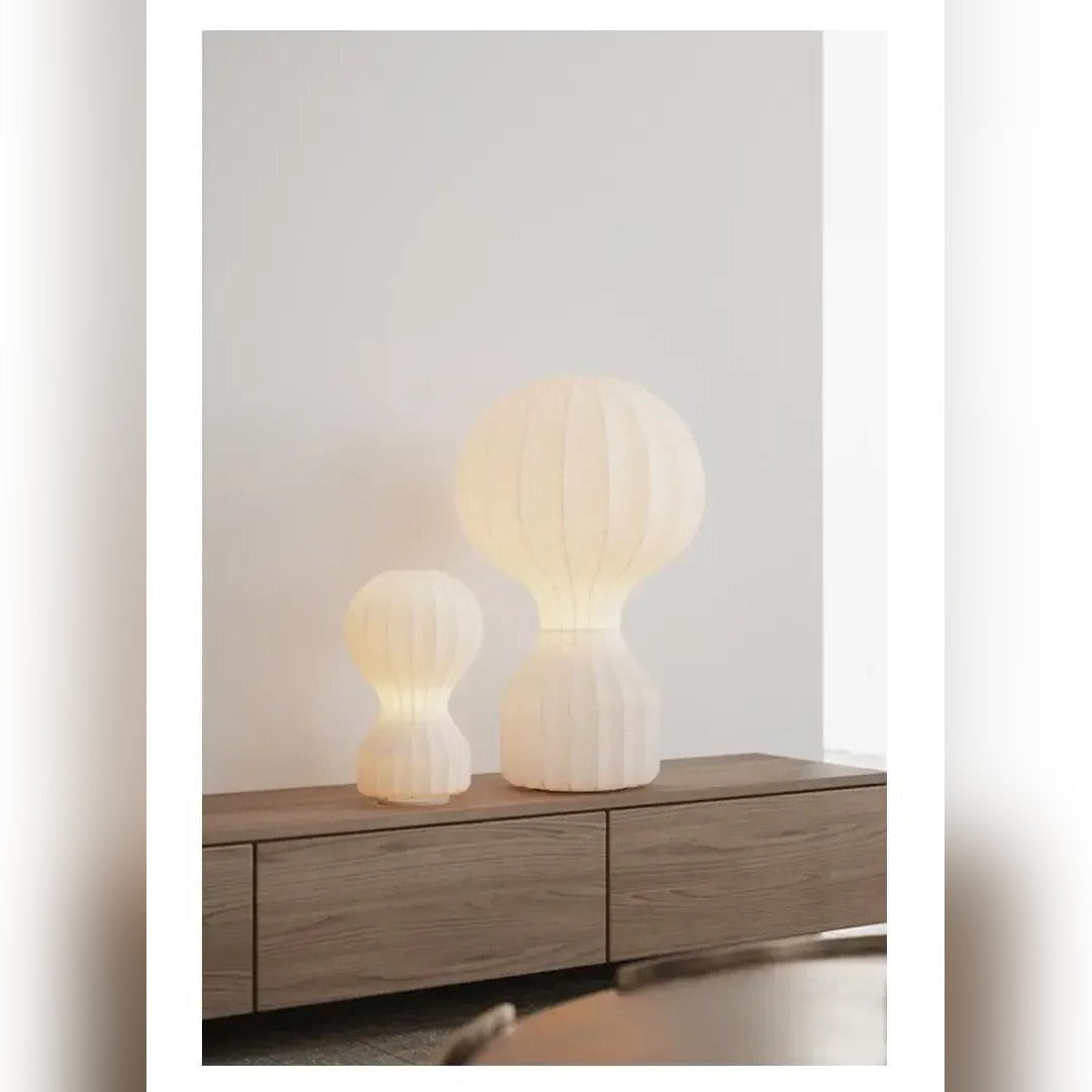Shirokaze silk cocoon table lamp — Small and Medium sizes together on a wood credenza, warm light