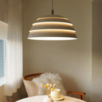 Tiered Dome LED Pendant Light Brevion — five horizontal light bands, bedroom above table