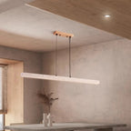Quarren travertine LED bar pendant in a modern interior with a warm wood ceiling accent