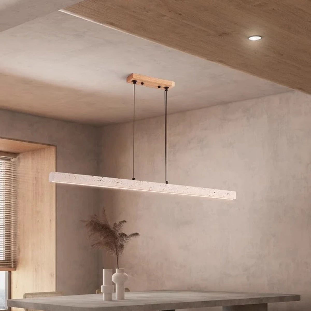 Quarren travertine LED bar pendant in a modern interior with a warm wood ceiling accent