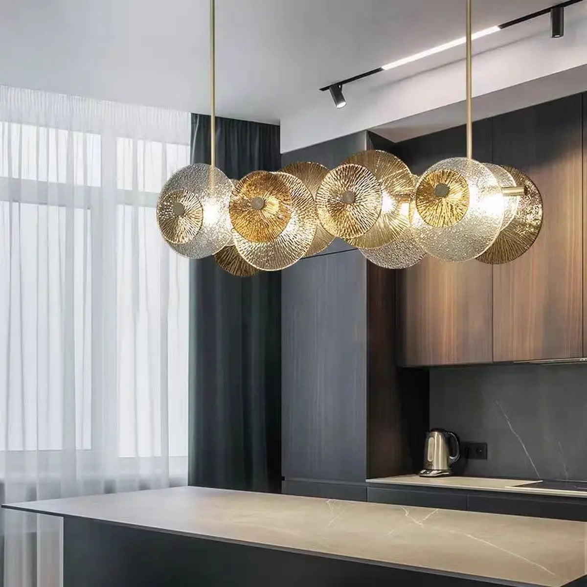 Iralux amber and clear glass disc chandelier over a kitchen island