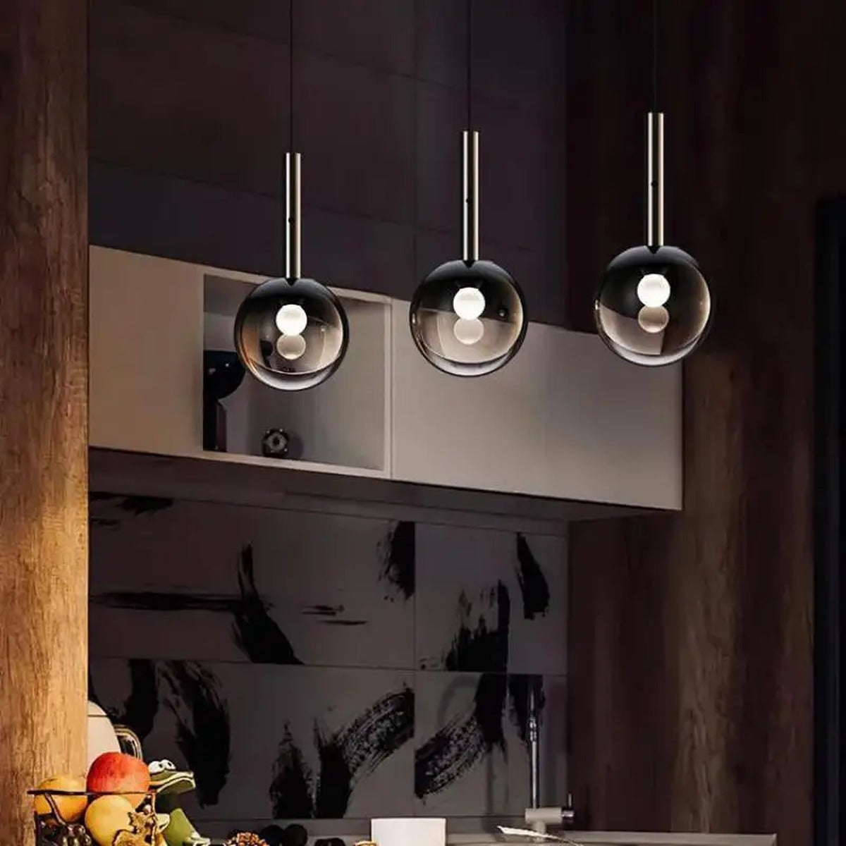 Three Prismavik pendant lights in a row above a kitchen island