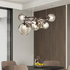 Stellarix Bubble Cluster Chandelier over a dining table, smoke grey glass finish, lit