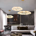 Orivex hexagonal alabaster pendants, shown as a trio cluster, over a living room seating area