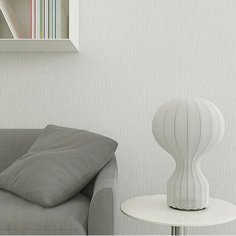 Shirokaze Small table lamp on a side table beside a grey sofa and bookshelf