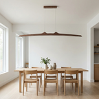 Firion sculptural wood linear pendant in walnut over a dining table