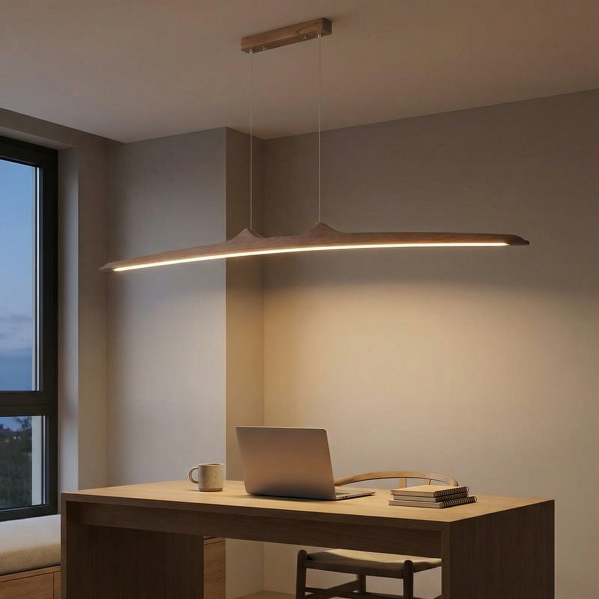 Firion walnut pendant lit warm white over a desk in the evening