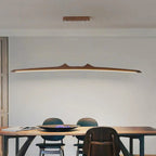 Firion walnut pendant over a dining table with chairs