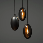 Ellyra lens pendant light in matte black, brushed gold and polished nickel, styled together