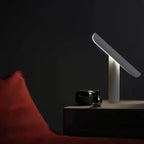 Izora lamp – Matte Black version showing diagonal arm and glowing aperture