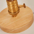 Cafenira lamp detail — brass Edison socket set into the light wood base