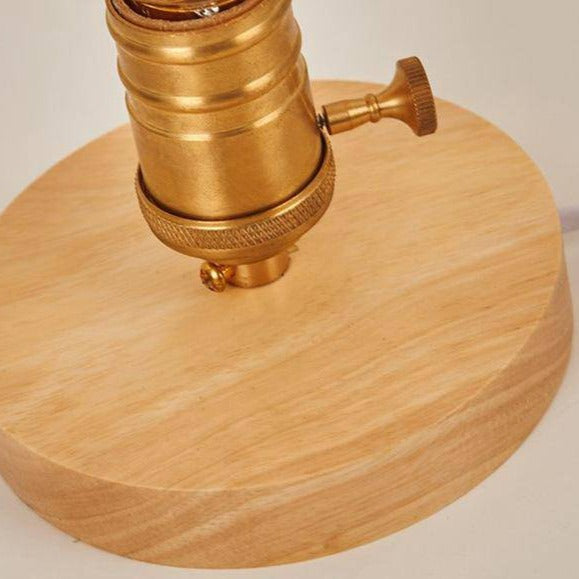 Cafenira lamp detail — brass Edison socket set into the light wood base