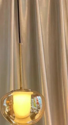 Mzaelvix glass globe pendant – amber glass with copper-finish hardware, warm light detail