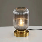 Nervira lamp – Forest Green ribbed glass version on dark surface