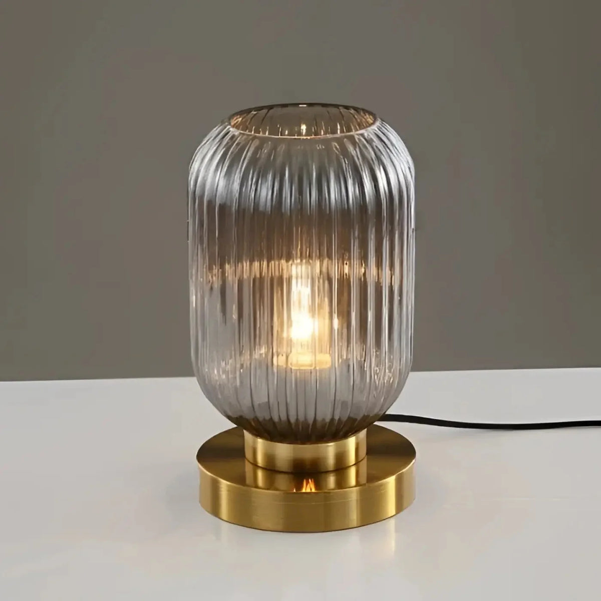 Nervira lamp – Forest Green ribbed glass version on dark surface