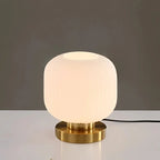 Nervira lamp – brass disc base and glass edge detail from below