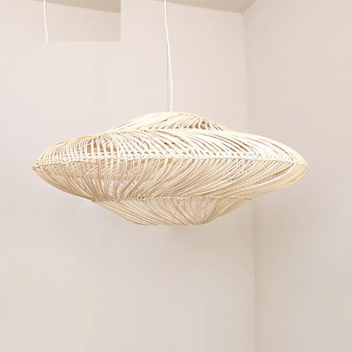 Nestara handwoven wicker dome pendant light in a warm neutral room