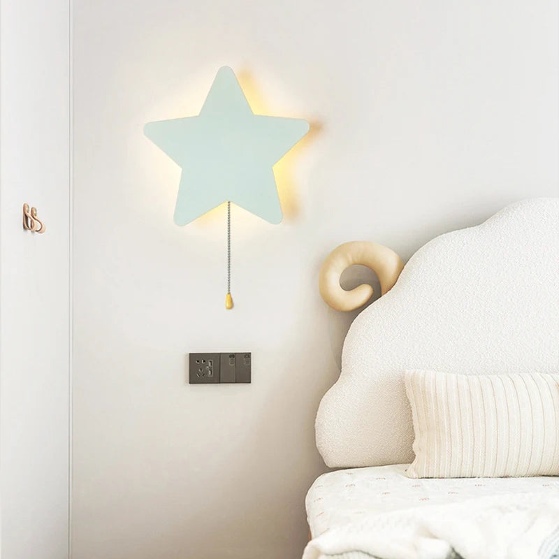 Nubira Star metal wall light illuminated above a bedroom nightstand