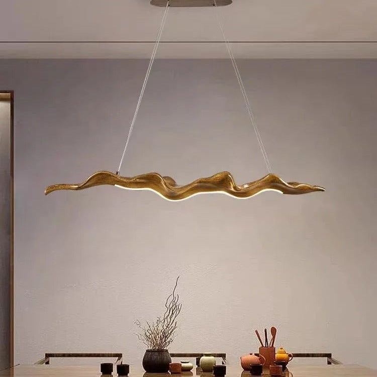 Sculptural wave-form pendant light Velorix wood-tone finish over tea table