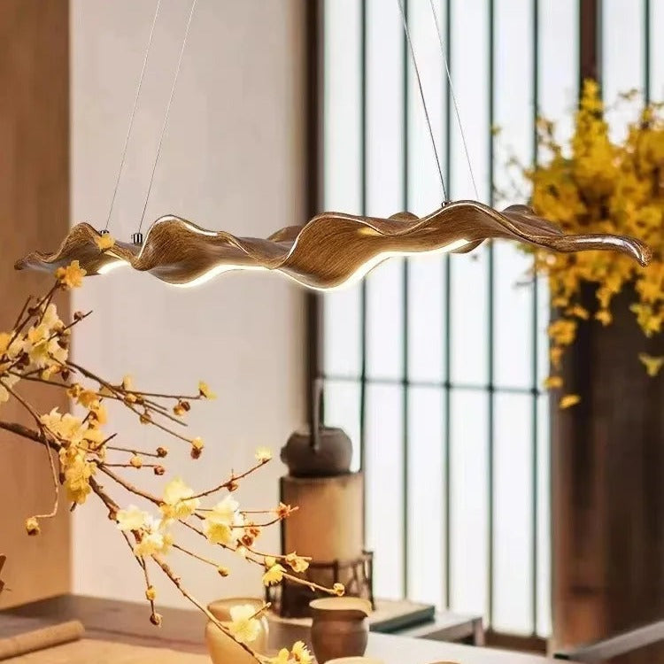 Sculptural wave-form pendant light Velorix wood-tone finish detail