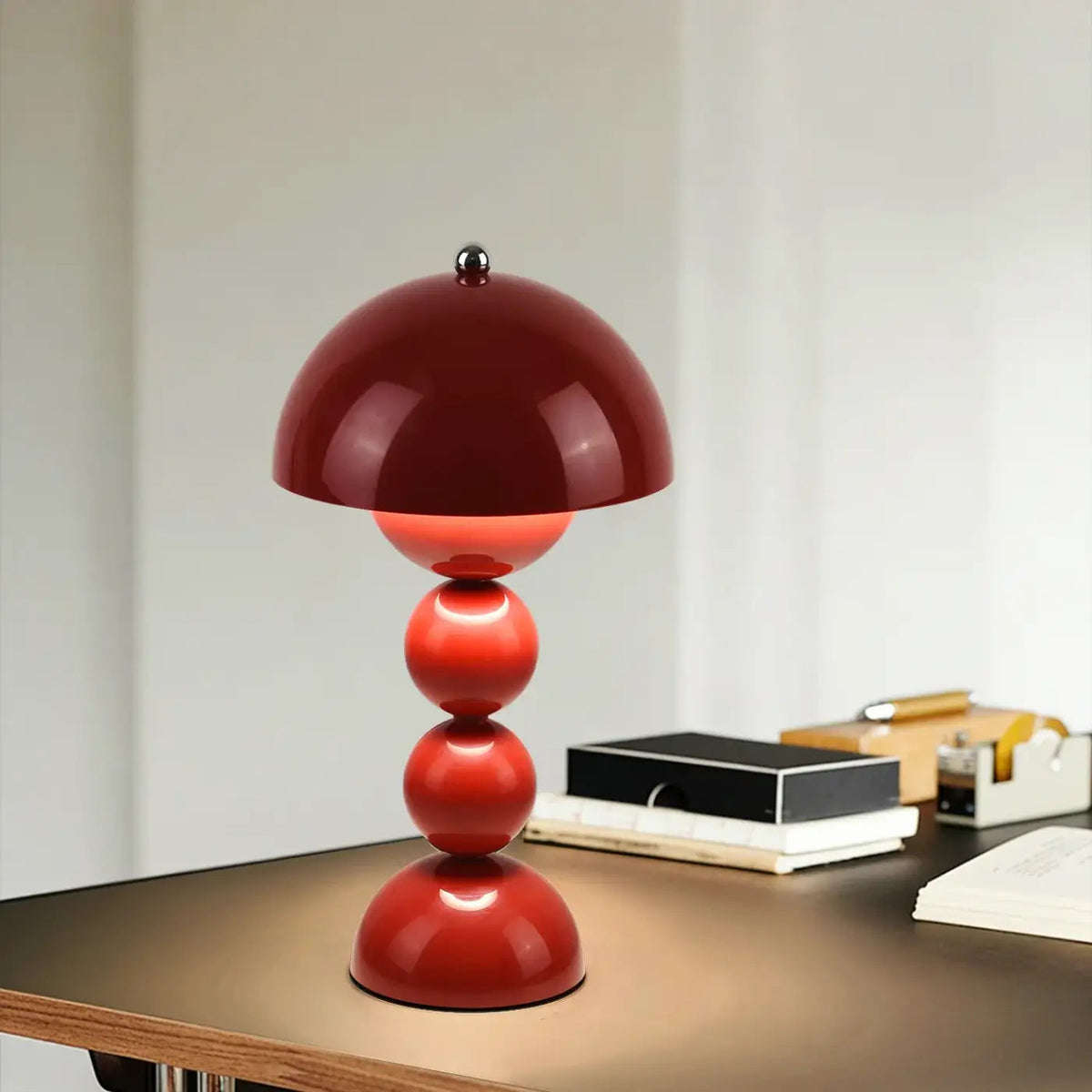 Velvara lamp on marble side table with books and plant