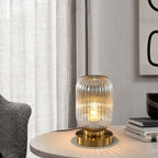 Vernita ribbed glass table lamp – Amber glass catching warm light