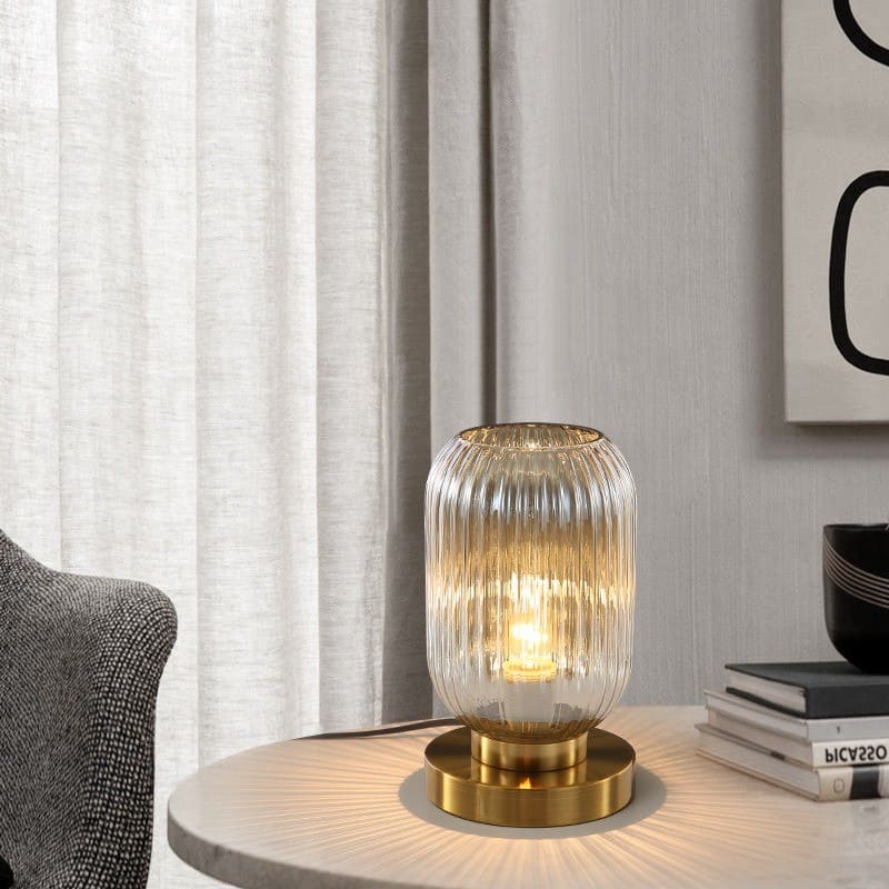 Vernita ribbed glass table lamp – Amber glass catching warm light
