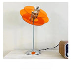 Zyneth retro acrylic disc table lamp – Amber Orange version on wooden shelf